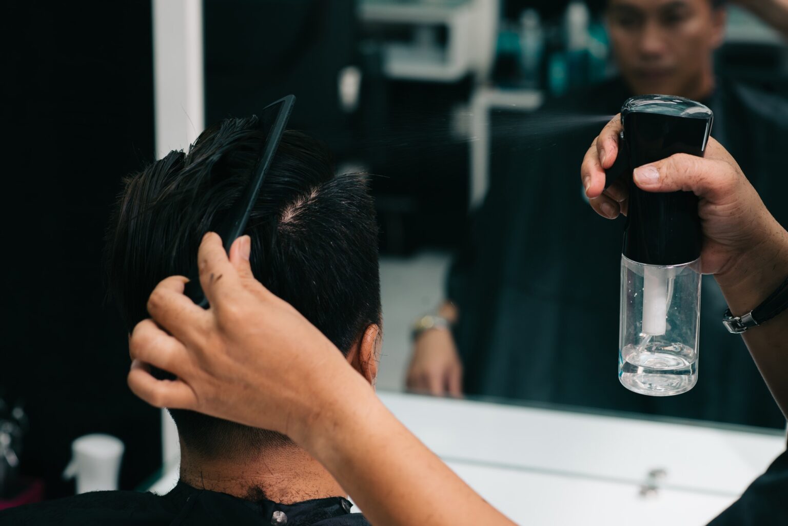 Applying hair treatment XO Salon Sunny Isles