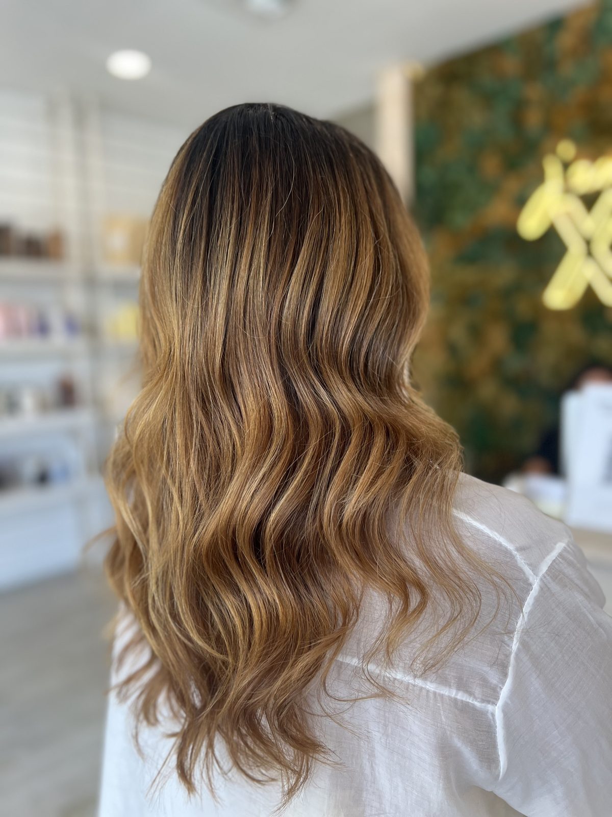 Soft waves blowout on long golden brunette hair at XO Salon & Spa in Sunny Isles Beach